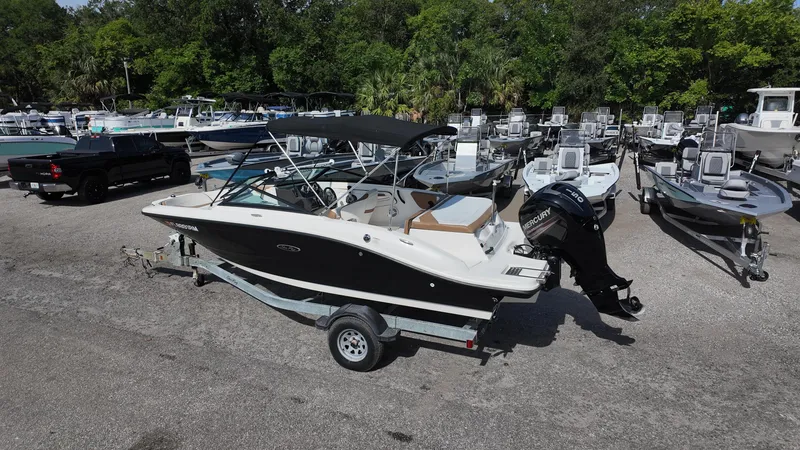Slide: The Image of 2018 Sea Ray 190 Bow Rider boat on trailer in marina lot. - 28
