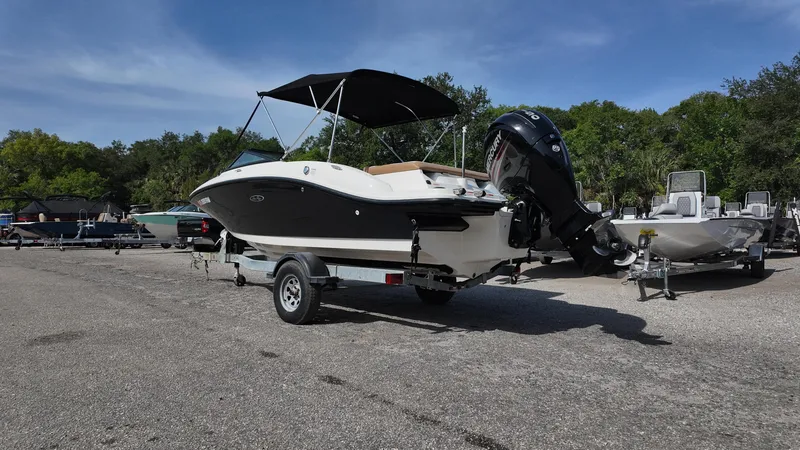 Slide: The Image of 2018 Sea Ray 190 Bow Rider boat on trailer, parked outdoors. - 30