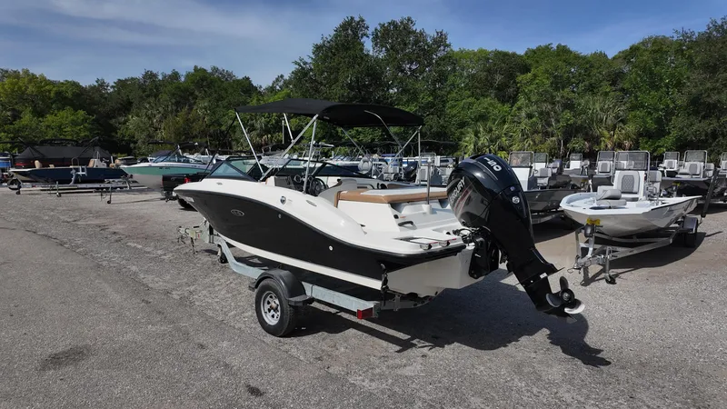 Slide: The Image of 2018 Sea Ray 190 Bow Rider boat on trailer in outdoor lot. - 31