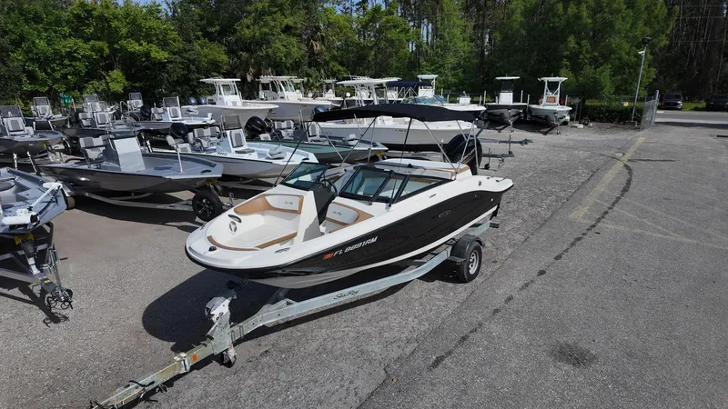 Slide: The Image of 2018 Sea Ray 190 Bow Rider boat on trailer in marina parking lot. - 5