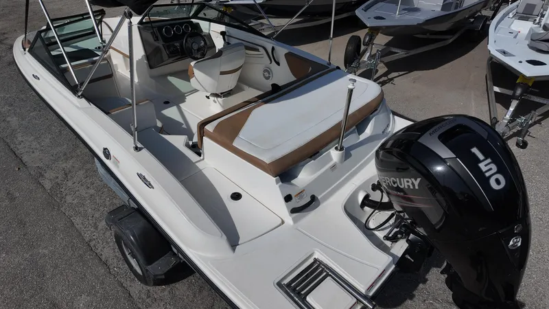 Slide: The Image of 2018 Sea Ray 190 Bow Rider boat with Mercury 150 engine, docked on pavement. - 6