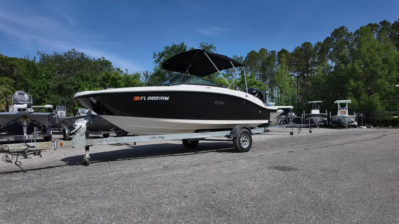 Slide: The Image of 2018 Sea Ray 190 Bow Rider boat on trailer in outdoor setting. - 7