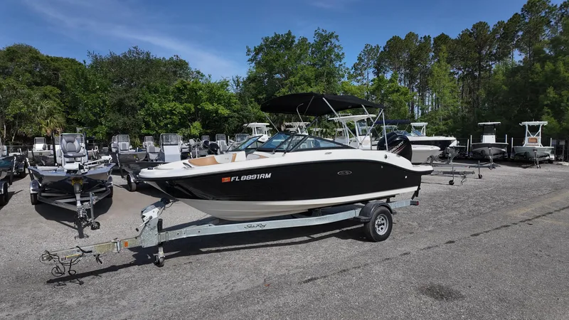 Slide: The Image of 2018 Sea Ray 190 Bow Rider boat on trailer in outdoor lot. - 8