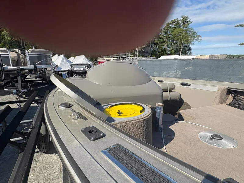 Slide: The Image of 2003 Tracker Targa 17 SC boat with seating, storage, and fishing equipment on a sunny day. - 2