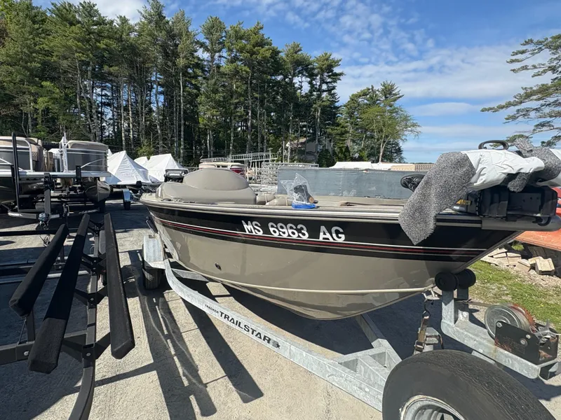 Slide: The Image of 2003 Tracker Targa 17 SC boat on trailer, parked outdoors with trees in background. - 3