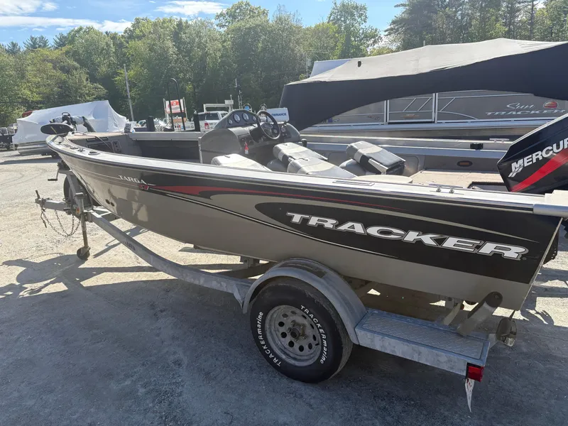Slide: The Image of 2003 Tracker Targa 17 SC boat on trailer, parked outdoors, with Mercury engine. - 7
