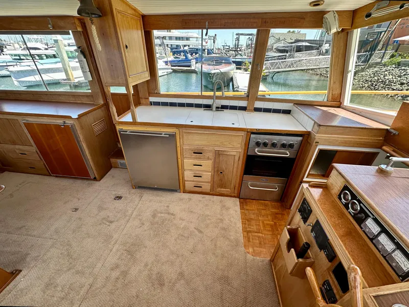Slide: The Image of Interior of a 1977 Grand Banks 42 Classic yacht with wooden cabinetry and marina view. - 2