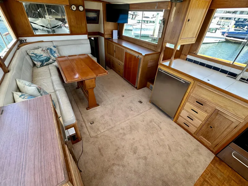 Slide: The Image of 1977 Grand Banks 42 Classic yacht interior with wood cabinetry and seating area. - 4