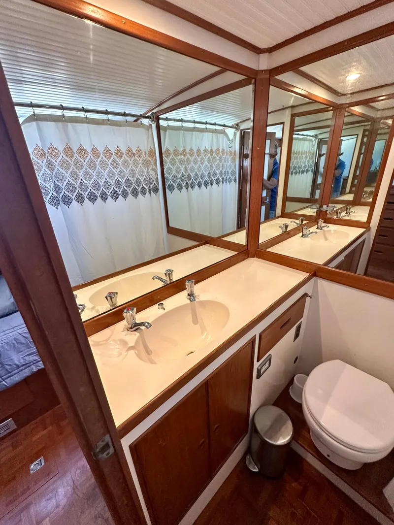 Slide: The Image of Bathroom interior of a 1977 Grand Banks 42 Classic yacht with dual sinks and wooden accents. - 6