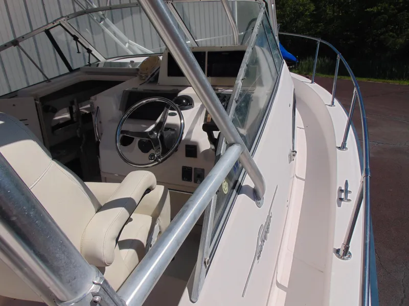 Slide: The Image of 2002 Grady-White 30 Marlin WA boat cockpit with steering wheel and seating. - 12