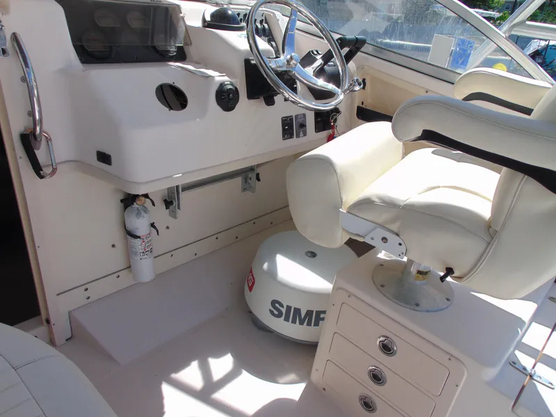 Slide: The Image of 2002 Grady-White 30 Marlin WA boat cockpit with steering wheel and seating. - 16