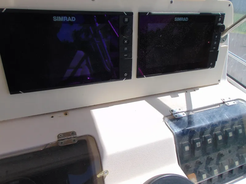 Slide: The Image of Control panel of 2002 Grady-White 30 Marlin WA with dual Simrad displays. - 18