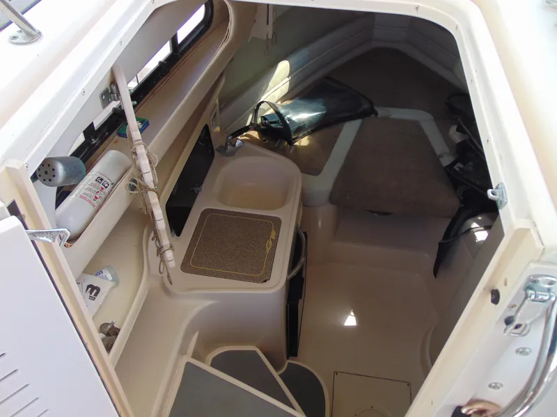 Slide: The Image of 2002 Grady-White 30 Marlin WA cabin interior with compact amenities and seating area. - 20
