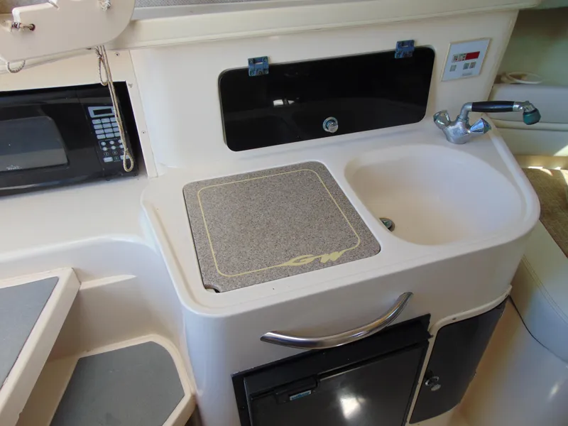 Slide: The Image of 2002 Grady-White 30 Marlin WA boat interior with sink, microwave, and storage. - 21