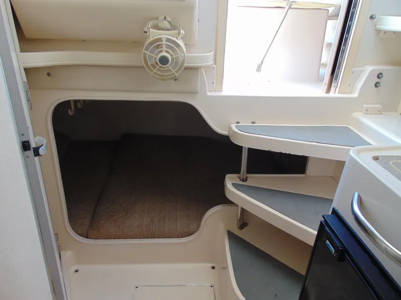 Slide: The Image of 2002 Grady-White 30 Marlin WA cabin interior with steps and compact sleeping area. - 24