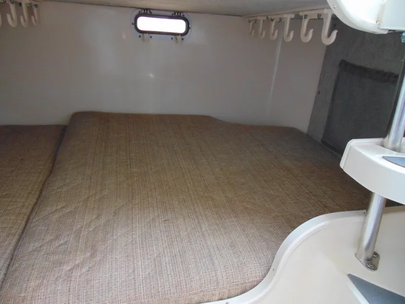 Slide: The Image of 2002 Grady-White 30 Marlin WA cabin interior with bed and hooks. - 25