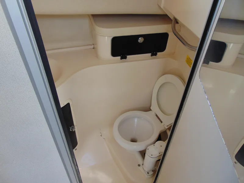 Slide: The Image of 2002 Grady-White 30 Marlin WA boat bathroom interior with toilet and storage. - 28