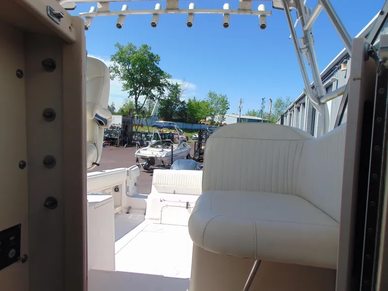 Slide: The Image of 2002 Grady-White 30 Marlin WA boat interior with white seating and outdoor view. - 30