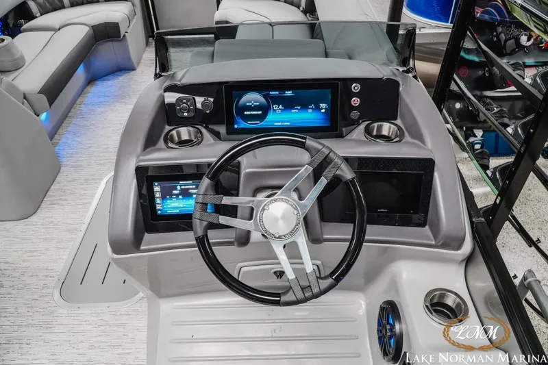 Slide: The Image of 2025 Bennington 24LXSFB boat dashboard with modern controls and steering wheel. - 10