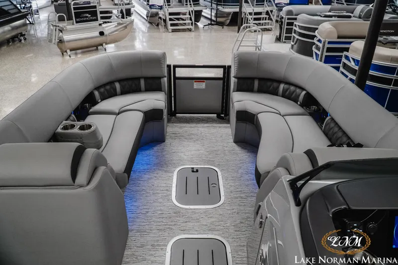 Slide: The Image of 2025 Bennington 24LXSFB pontoon boat interior with luxurious gray seating and ambient lighting. - 12