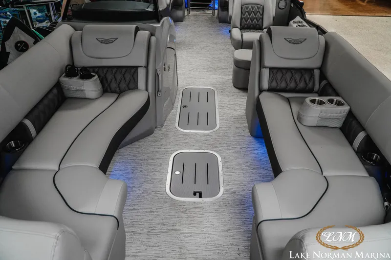 Slide: The Image of 2025 Bennington 24LXSFB boat interior with luxurious gray seating and cup holders. - 13