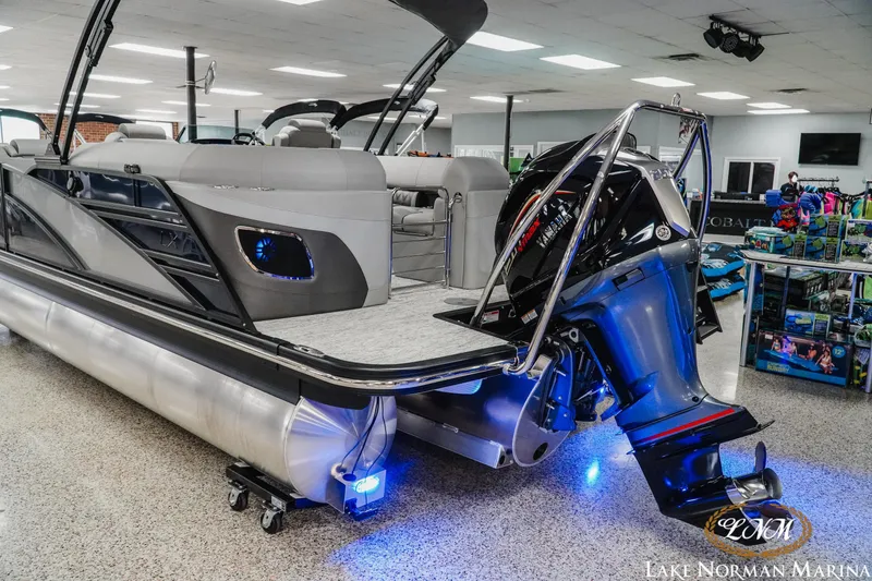 Slide: The Image of 2025 Bennington 24LXSFB pontoon boat with sleek design and powerful outboard motor. - 4