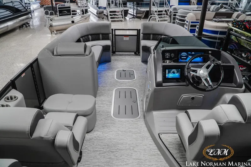 Slide: The Image of 2025 Bennington 24LXSFB pontoon boat interior with modern seating and control panel at Lake Norman Marina. - 8