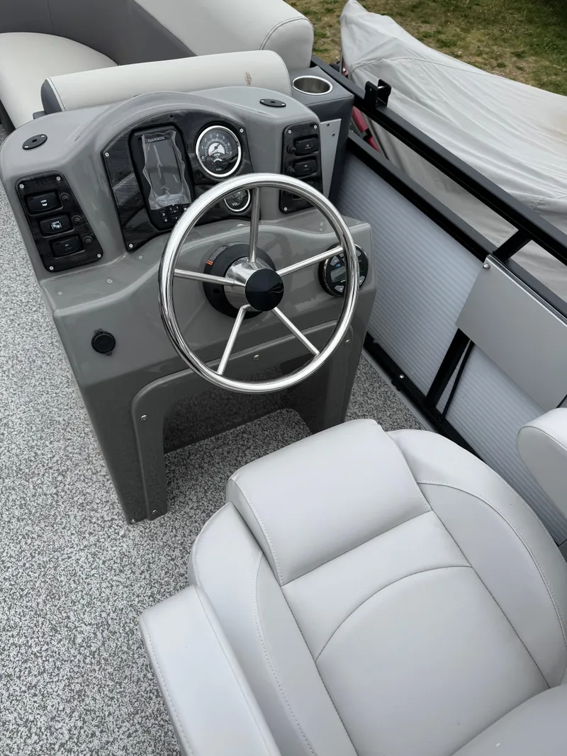 Slide: The Image of 2025 Angler Quest 816 Panfish Cruise boat interior with steering wheel and control panel. - 10