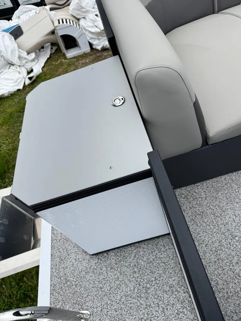 Slide: The Image of 2025 Angler Quest 816 Panfish Cruise boat interior with gray seating and storage compartment. - 13