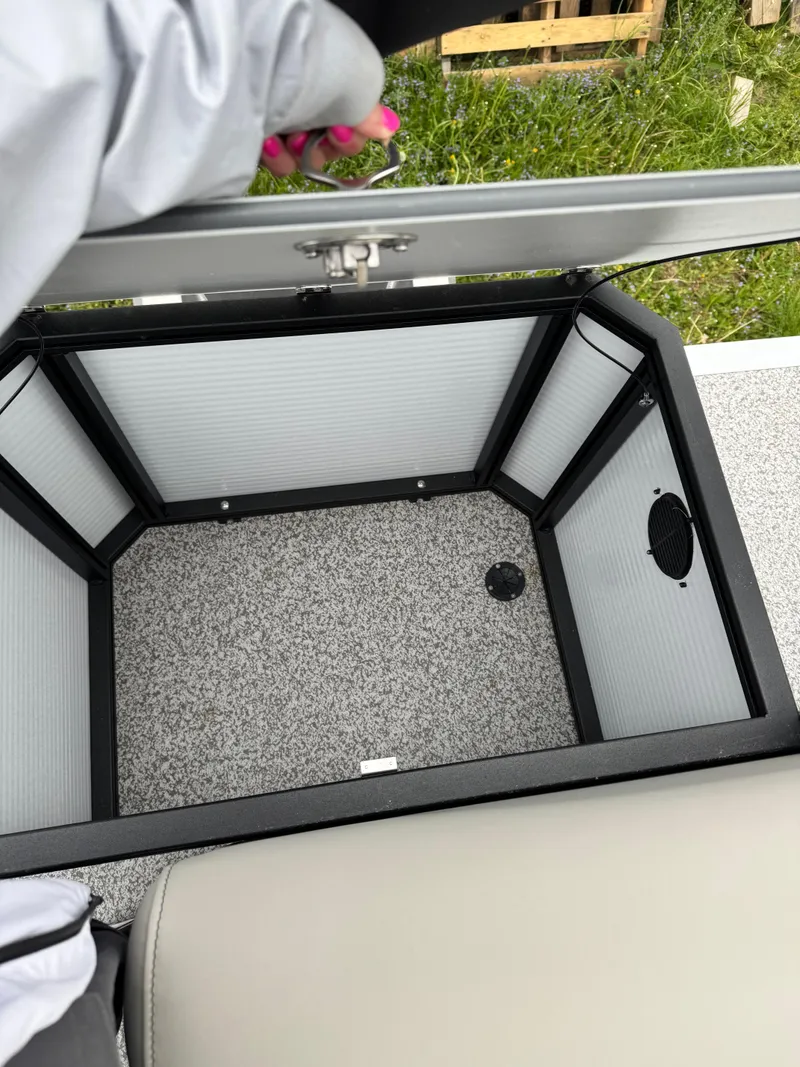 Slide: The Image of 2025 Angler Quest 816 Panfish Cruise storage compartment with open lid, showcasing interior space. - 14
