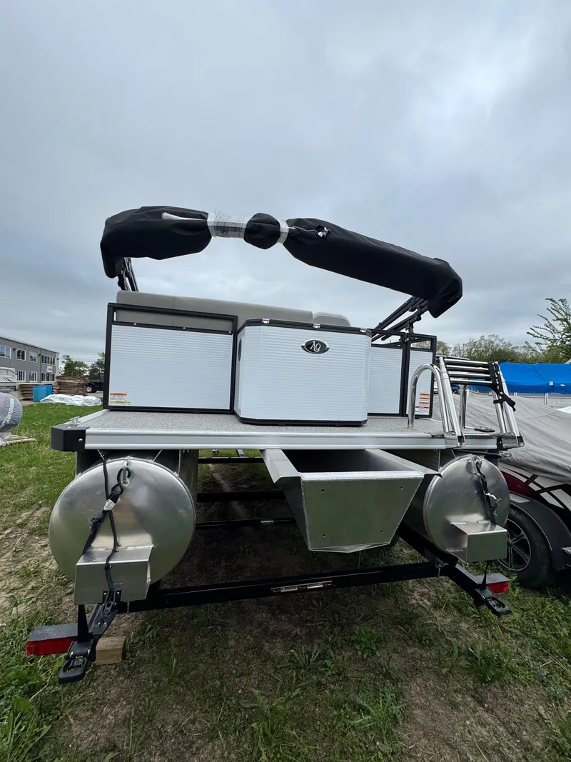 Slide: The Image of 2025 Angler Quest 816 Panfish Cruise pontoon boat on grassy area, overcast sky. - 3