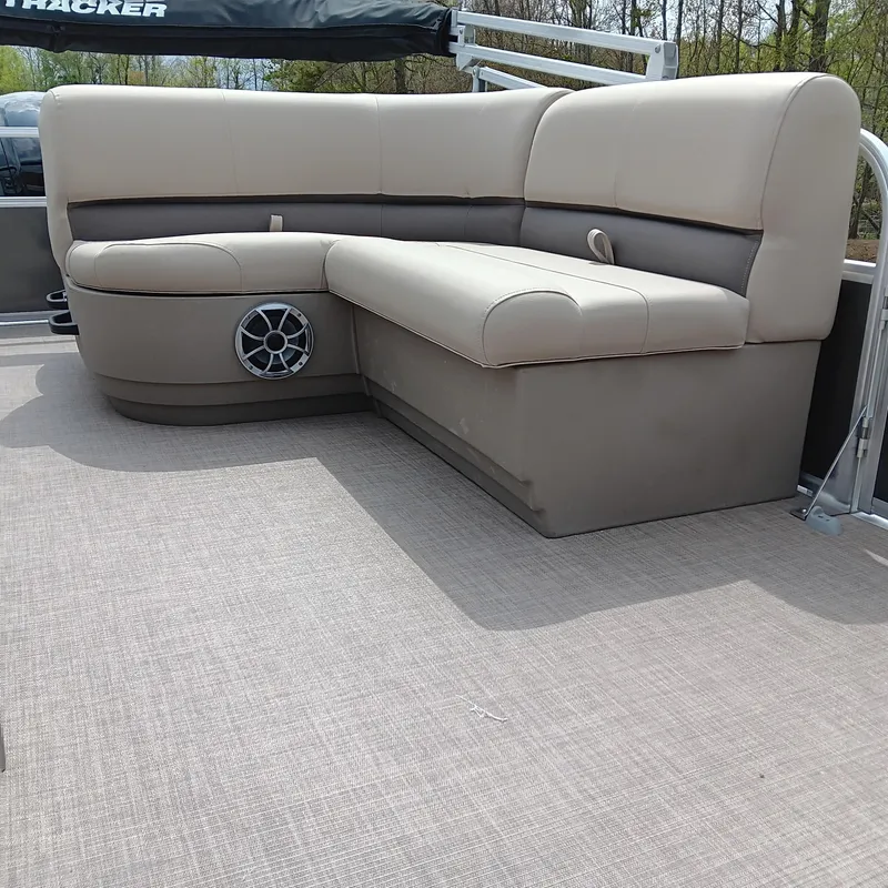 Slide: The Image of 2025 Sun Tracker Party Barge 18 DLX interior seating with speaker, beige upholstery. - 10