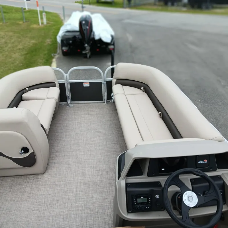 Slide: The Image of 2025 Sun Tracker Party Barge 18 DLX pontoon boat with spacious seating and modern dashboard. - 5