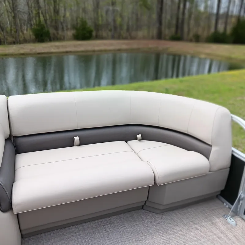 Slide: The Image of 2025 Sun Tracker Party Barge 18 DLX seating by a serene pond. - 6