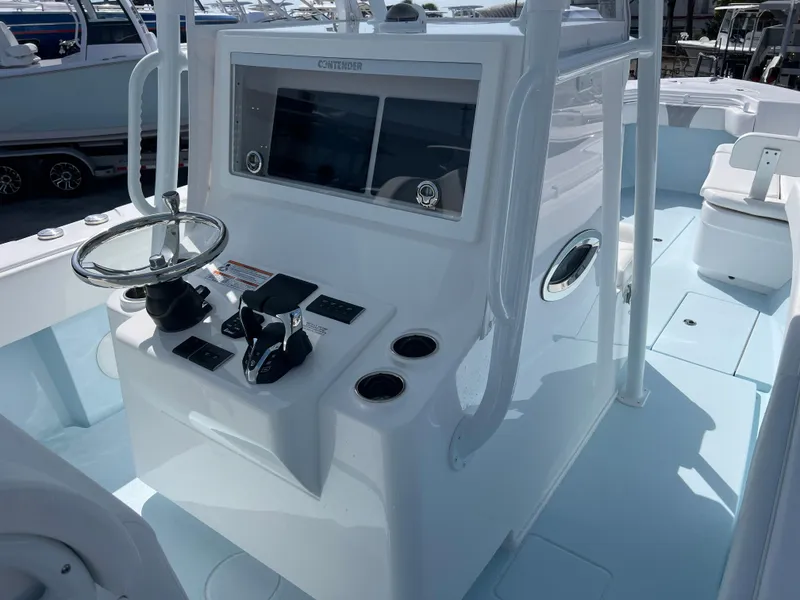 Slide: The Image of 2025 Contender 30 ST boat console with steering wheel and controls. - 10