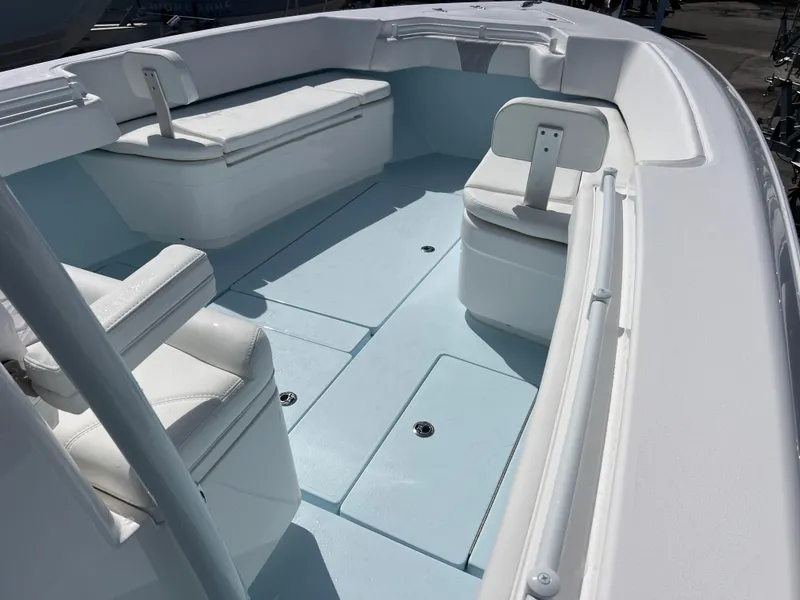Slide: The Image of 2025 Contender 30 ST boat interior with white seating and spacious deck layout. - 14