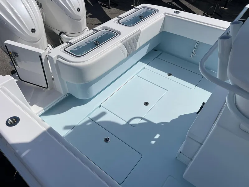 Slide: The Image of 2025 Contender 30 ST boat deck with storage compartments and twin outboard engines. - 19