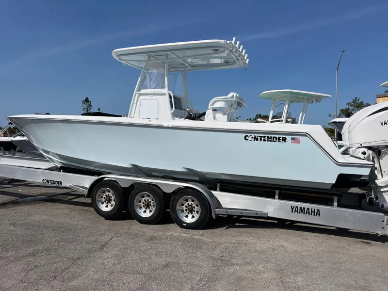 Slide: The Image of 2025 Contender 30 ST boat on a Yamaha trailer, parked outdoors. - 3