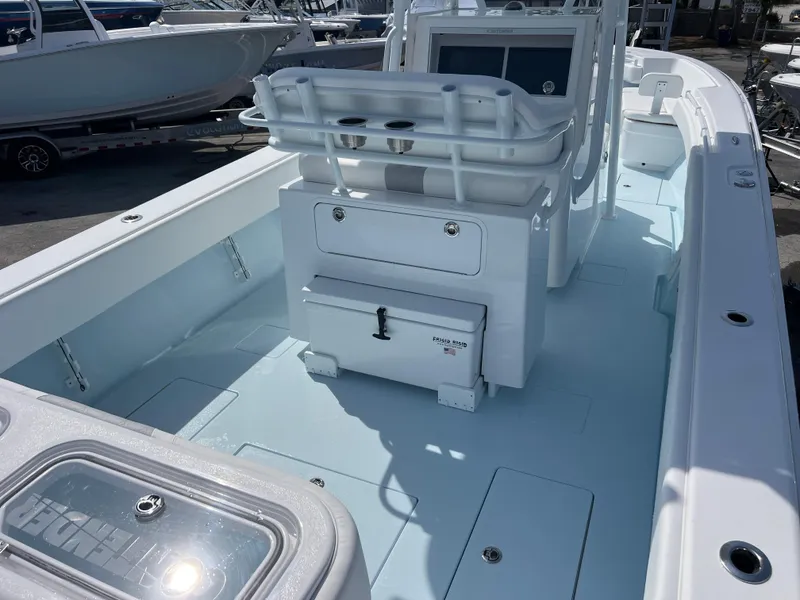 Slide: The Image of 2025 Contender 30 ST boat interior with seating and storage, docked in a marina. - 8