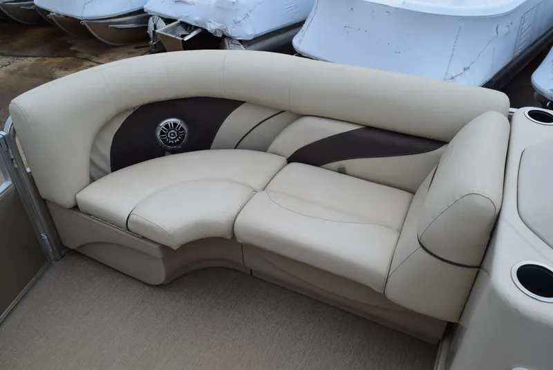 Slide: The Image of 2014 SunChaser Classic Cruise 8520 boat seating with beige upholstery and integrated speaker. - 12