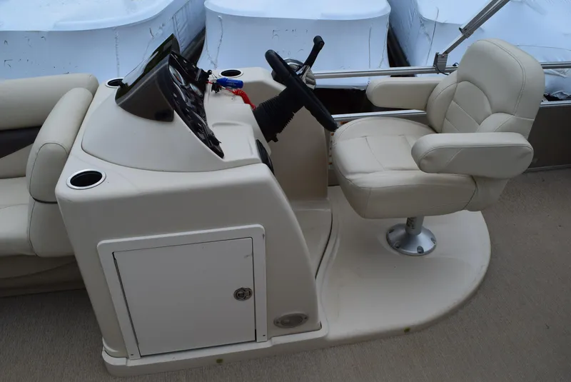 Slide: The Image of 2014 SunChaser Classic Cruise 8520 boat helm with beige captain's chair and control panel. - 13