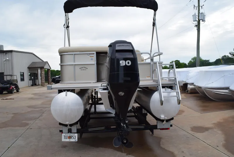 Slide: The Image of 2014 SunChaser Classic Cruise 8520 pontoon boat with Mercury 90 engine, parked outdoors. - 2