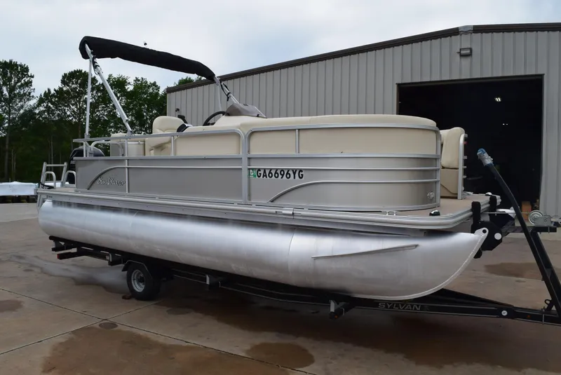 Slide: The Image of 2014 SunChaser Classic Cruise 8520 pontoon boat on trailer outside a warehouse. - 4