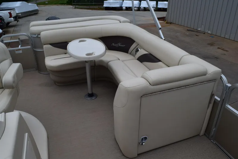 Slide: The Image of 2014 SunChaser Classic Cruise 8520 pontoon boat with beige seating and round table. - 8