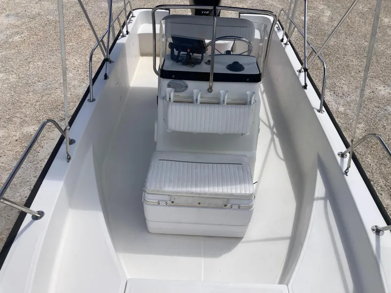 Slide: The Image of 2005 Boston Whaler 170 Montauk boat interior with seating and console. - 10
