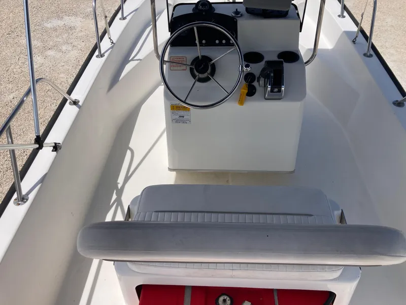 Slide: The Image of 2005 Boston Whaler 170 Montauk boat interior with steering wheel and seating. - 6