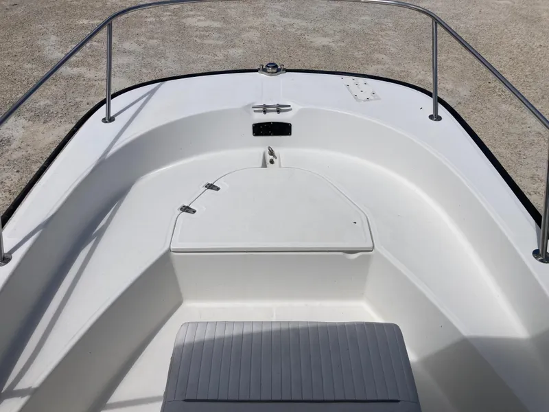 Slide: The Image of 2005 Boston Whaler 170 Montauk boat interior with white deck and storage compartment. - 9