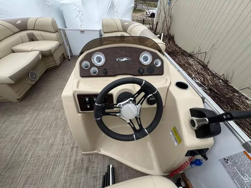 Slide: The Image of 2019 Starcraft EX 20 R boat dashboard with steering wheel and beige seating. - 10