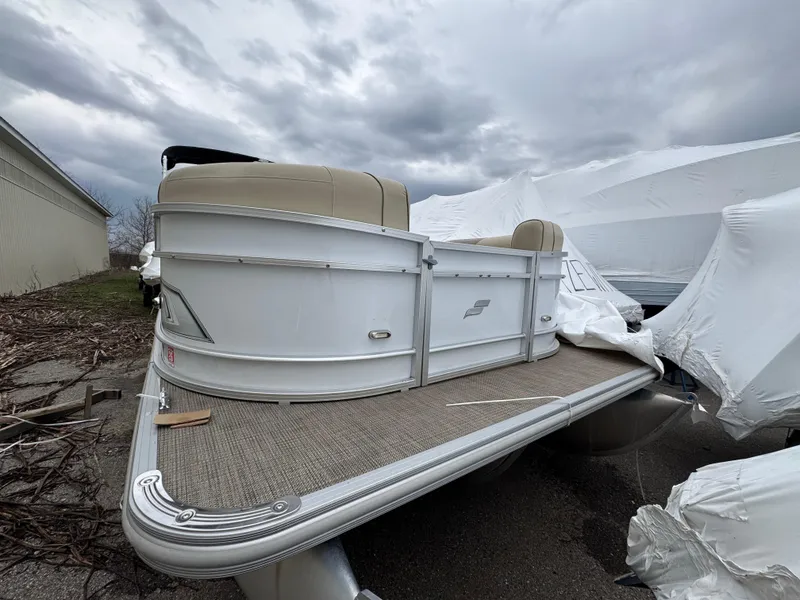 Slide: The Image of 2019 Starcraft EX 20 R pontoon boat on a cloudy day, partially covered. - 12