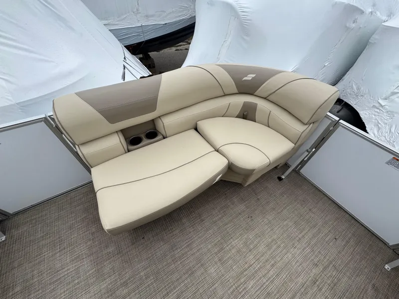 Slide: The Image of 2019 Starcraft EX 20 R boat interior with beige seating and cup holders. - 2